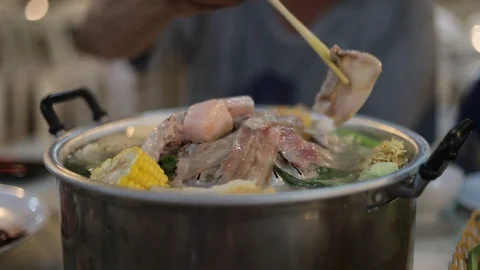 The pan for Thai Barbecue or with raw pork on top of Thai traditional stove. Stock-Footage 107549320