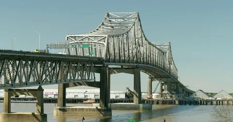 Pan Tilt from blue sky to i10 interstate 10 Mississippi River bridge tilt down Stock Footage