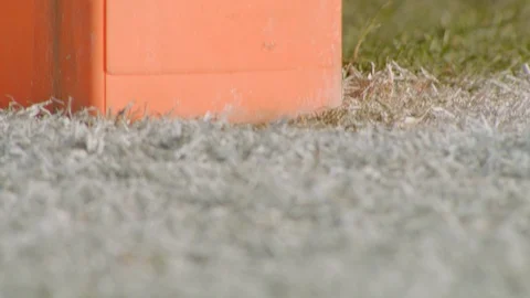 Pan tilt to camera embedded in end zone pylon in football field Stock Footage 102103985