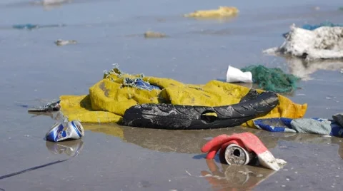 Pan tilt close up shot of plastic garbage and trash on the beach Stock Footage 50787079