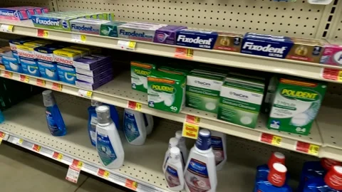 Pan of toothpaste section and prices at KJs retail supermarket Stock Footage 178683816