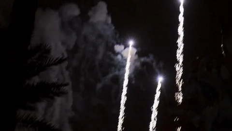 Pan up tracking shot of fireworks exploding Stock Footage 100390279