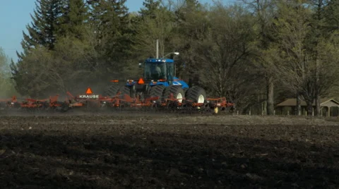 Pan of a tractor in the field plowing in late fall Stock Footage 52530376