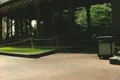Pan up from traditional building next to mirrored Hancock building skyscraper Footage