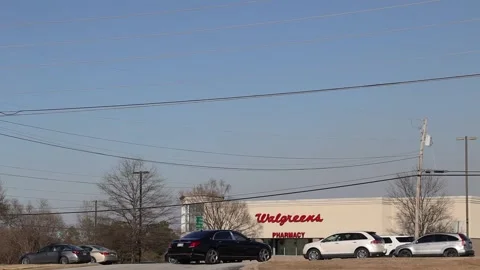 Pan of traffic and a Walgreens retail store Stock Footage 149221593