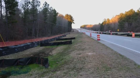 Pan of Traffic on a road construction highway with road work signs and cones  Stock Footage 147518959