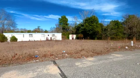 Pan of a trailer trash and waste build up on the side of the roads Stock Footage 148400399