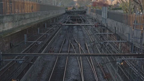 Pan up of the train and metro lines in the middle of the city of Paris in Stock Footage 105353439