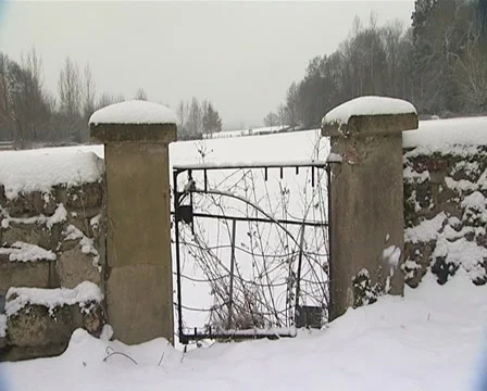 Pan from tree to old gate in the snow Stock Footage 32541620