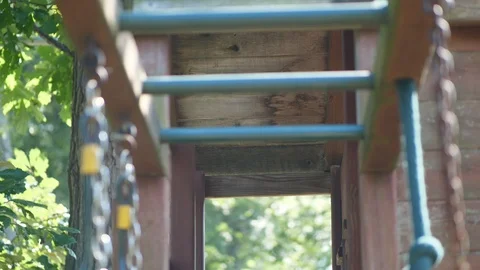 Pan from trees to monkey bars playset club house grass summer in Garden with Video stock 95033139