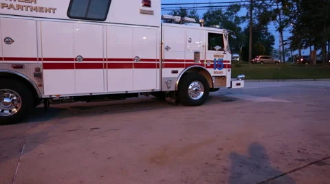 Pan to two firemen talking outside of a fire department Stock Footage 66548746
