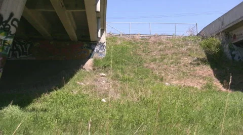 Pan under a concrete overpass full of graffiti Stock Footage 661290