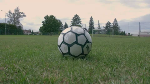 Pan upward from soccer ball to an empty goal Stock Footage 153378054