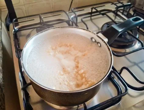 Pan in use, while cooking pasta. Stock Photos