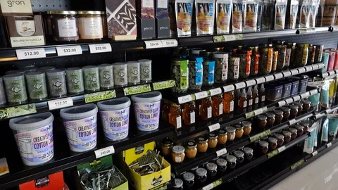 Pan of various CBD infused edible products on a shelf inside retail store. Stock Footage