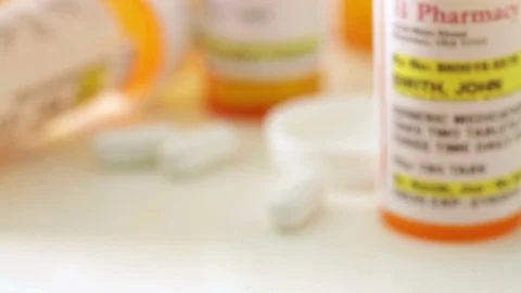 Pan of Various Fictitious Nonproprietary Prescription Medicine Bottles. Stock Footage