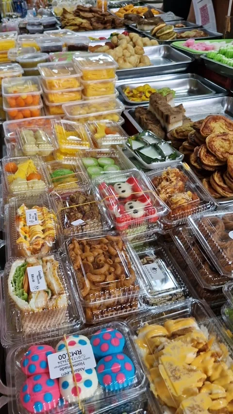 Pan up of various types of Malay dishes (kueh muih) in plastic packaging 库存影片 330108307