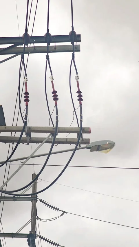 Pan up video cable terminators on a high voltage concrete pole, industrial. Stock Footage 345128570