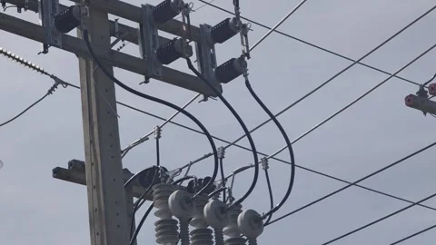 Pan up video of a high voltage automatic circuit on a concrete pole. Видео 340376872
