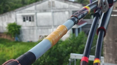 Pan up video of an ongoing jointing process on twisted aerial cables showin. Stock Footage 345129078