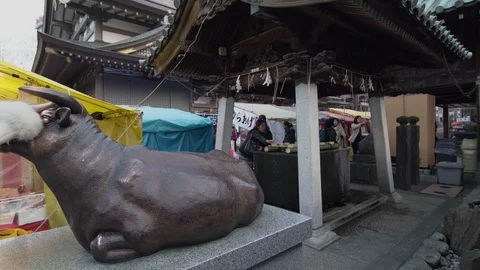 Pan video of a statue of ox worn in Yushima Tenmagu shrine. Stock Footage 128208644