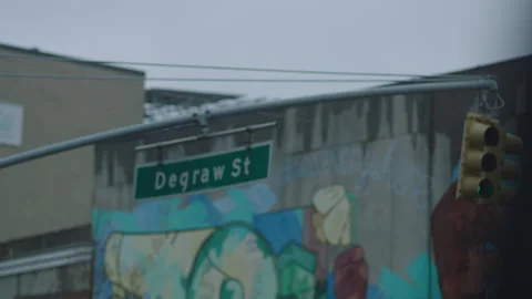 Pan view to 4th ave and degraw street intersection in downtown brooklyn nyc Stock Footage 251216151