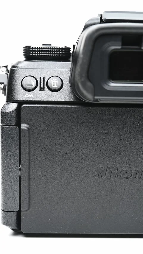 Pan view back of a Nikon brand new camera Z6III on white at vertical composition Stock Footage 279397523
