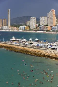 Pan view of Benidorm Poniente beach with port, skyscrapers, boats and mountai Stock Photos