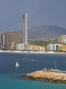 Pan view of Benidorm Poniente beach with port, skyscrapers, boats and mountains Stock Photos