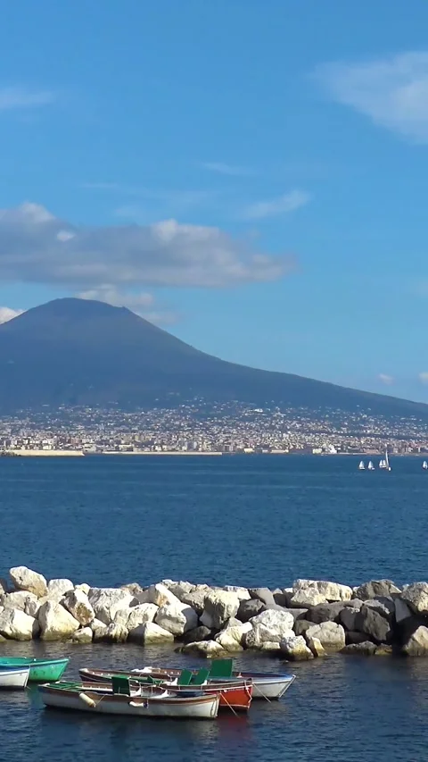 Pan view of boats with Mount Vesuvius Gulf of Naples Italy coastal landscape Видео 332442398