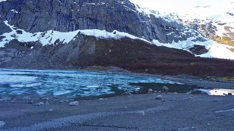 Pan view of briksdal glacier in Norway with frozen ice lake 動画素材 90728404