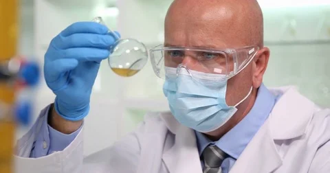 Pan View Chemist Wearing Protection Equipment Test and Mixing Liquid Solutions Stock Footage 83686321