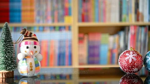 Pan view Christmas decorations in front of a book shelf in a living room Stock Footage 165918744