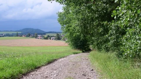Pan view of country path and landscape Stock Footage