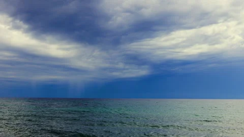 Pan view dramatic clouds above a calm sea horizon view Stock Footage 294711842