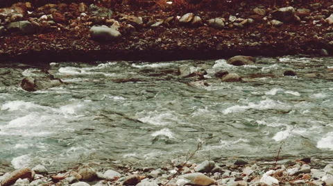 Pan view of fast-flowing mountain river in winter Stock Footage 61073067
