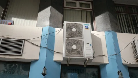Pan view of a group of outdoor old air conditioning system on a wall. Stock Footage 121959191
