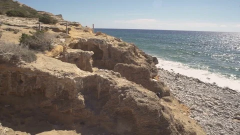 Pan view on Ibiza's stone beach Video stock 83044457