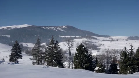 Pan View of Mountain Ridge and Snow Covered Mountains, Traditional Village and Stockbeeldmateriaal 72176136