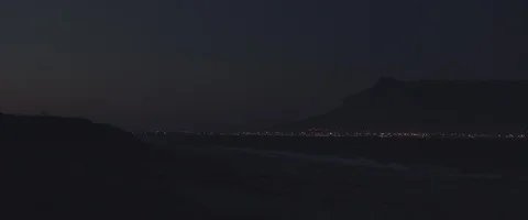 Pan view of a moutain low light with city light - UHD Prores 422 Stock Footage 103855391