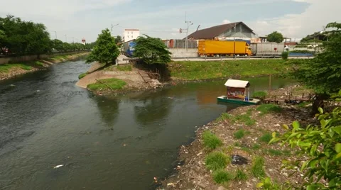 Pan view muddy rivers merging, tiny cable ferry, road traffic, sounds Stock Footage 51555023