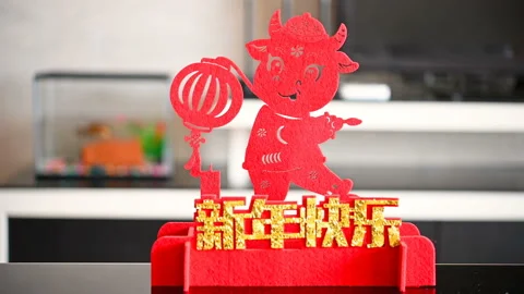 Pan view ox mascot with a lantern in a living room as symbol of Chinese New Y Stock Footage 147924864