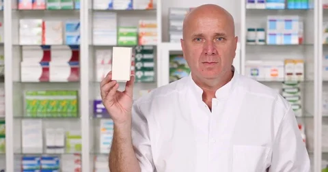 Pan View Pharmacy Employee Keep in Hand a Box with Pills Recommended for Cure Stock-Footage 83674277