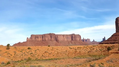 Pan view on a red sand and mountains at a navajo desert, at monument valley.. Stock Footage 71659119