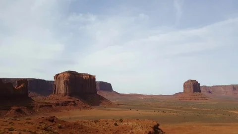 Pan view on a red sand and mountains at a orange desert, at monument valley.. Stock Footage 72395822
