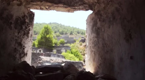 Pan up to view of Remote Eastern Village seen through window of stone cottage Stock Footage 40471708