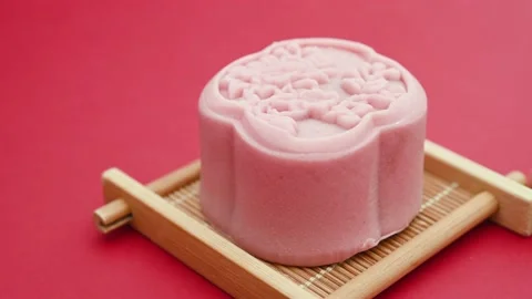 Pan view trendy flower shape mooncakes on red background Stock Footage 208003261