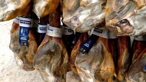 Pan view on whole cured hams displayed vertically. Stock Footage 122197300
