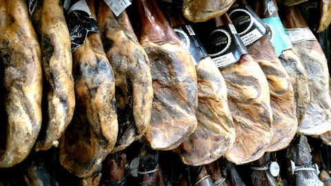 Pan view on whole cured hams displayed vertically. Stock Footage 122197301