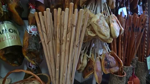 Pan up of walking sticks, baskets and meats for sale in Andalusia, Spain Видео 56477490